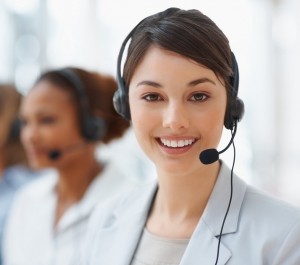 Closeup of a call center employee with headset at workplace